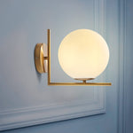 Dimmable Glass Globe Sconces With Brass Arm - Image 1